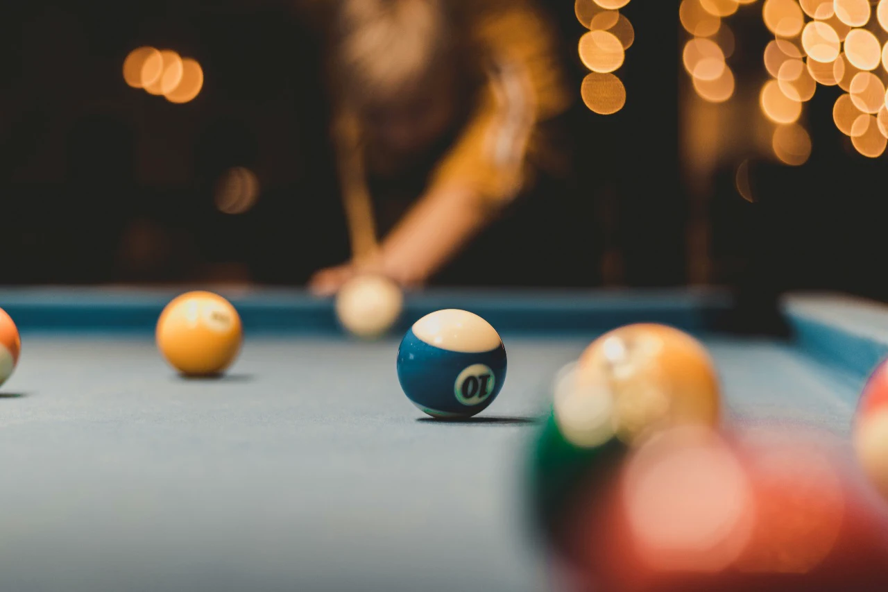 Find a bar with a pool table or dartboard and play a quick game or two — easy competition, easy laughs.